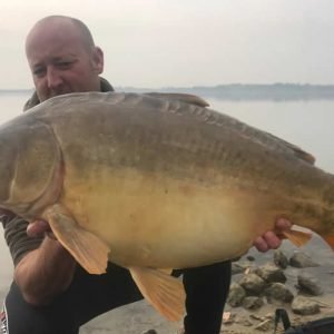 Nice shot of man holding carp