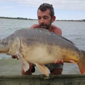 Nice shot of man holding carp