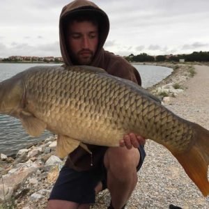 Nice shot of man holding carp