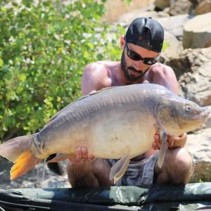 Nice shot of man holding carp