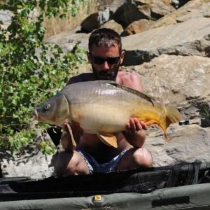 Nice shot of man holding carp