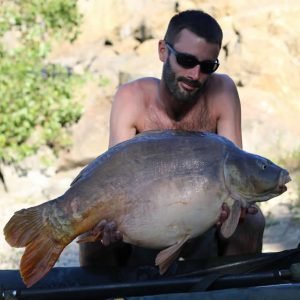 Nice shot of man holding carp