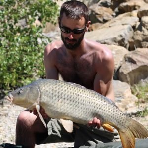 Nice shot of man holding carp