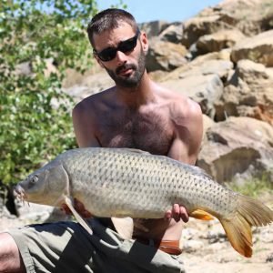 Nice shot of man holding carp