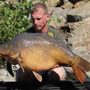 Nice shot of man holding carp