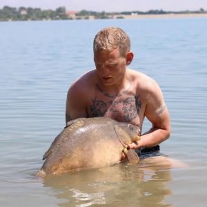 Nice shot of man holding carp