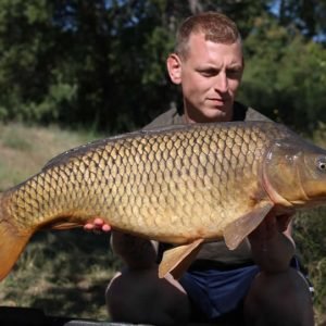 Nice shot of man holding carp fish