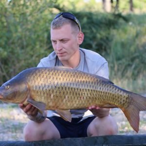 Nice shot of man holding carp