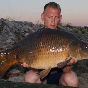 Man with large carp fish